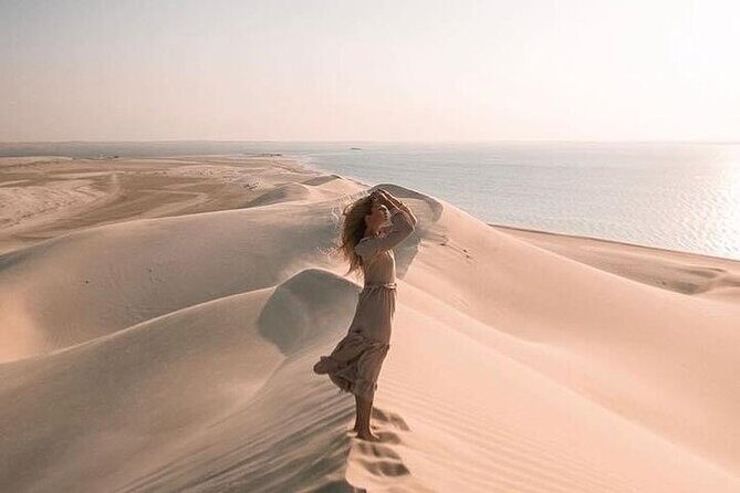 Doha Half Day Desert Safari Dune Bashing CamelRide & Sandboarding - Sandboarding at the dunes: the payoff after the adrenaline
