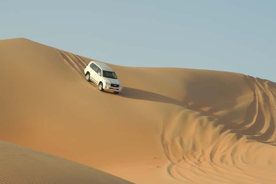 Doha Safari: ATV Ride, Dune Bashing, & Sandboarding Fun - Doha to the dunes in a 4x4: oil refineries and fast-changing scenery